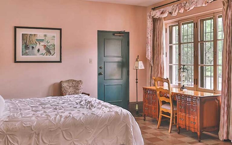 bed desk and window of suite at the lodge at wakulla springs tallahassee