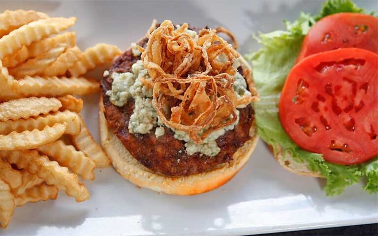 bleu cheese burger with crispy onions and sides at 3 sisters speakeasy kissimmee