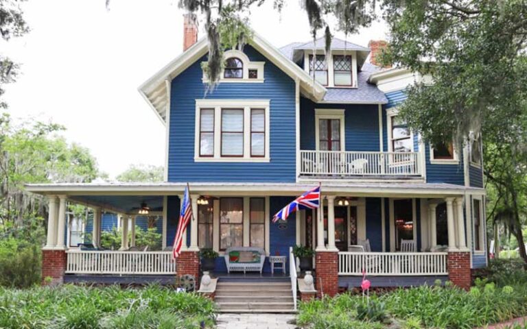 blue and white victorian style house with porch and trees at hoyt house bed breakfast fernandina beach amelia island