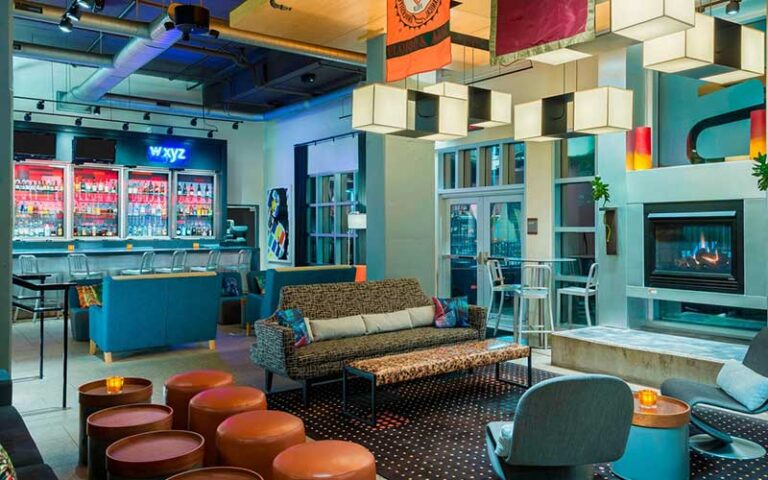 colorful lounge with fireplace and bar at aloft downtown tallahassee