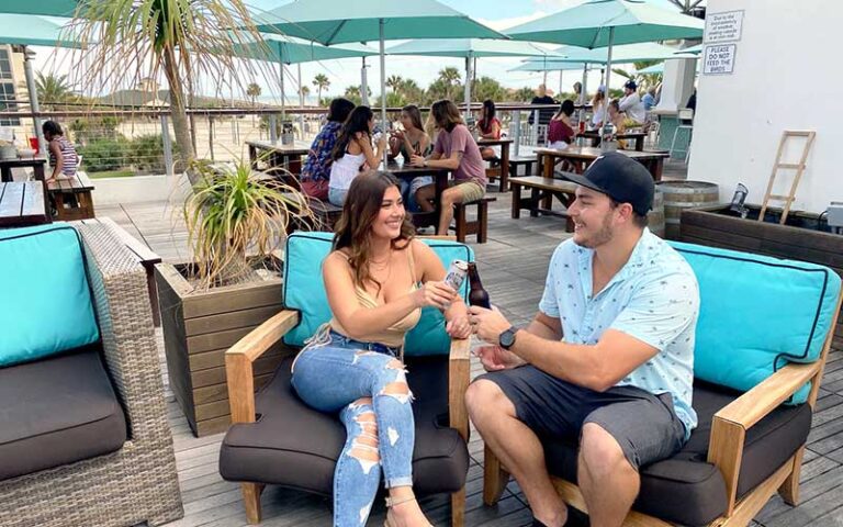 couple toasting on patio seating at salt life food shack fernandina beach