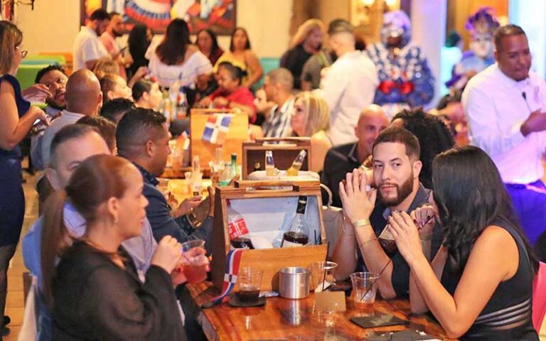 crowded dining area with colorful art at perico ripiao latin food kissimmee