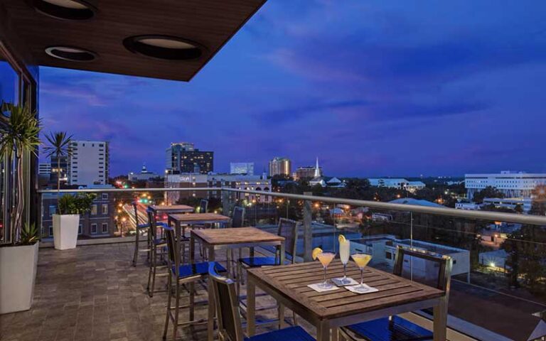 dining area balcony with night city view at hotel duval autograph collection tallahassee