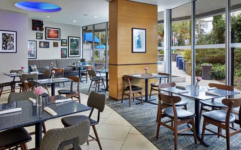 dining area in restaurant with floor to ceiling windows at four points by sheraton tallahassee downtown