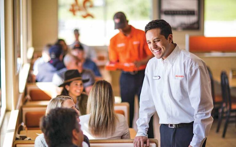 dining area of restaurant with manager greeting customers at whataburger west pensacola