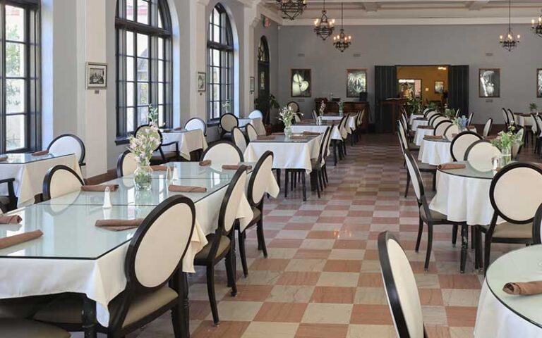 dining hall with table settings and windows at the lodge at wakulla springs tallahassee