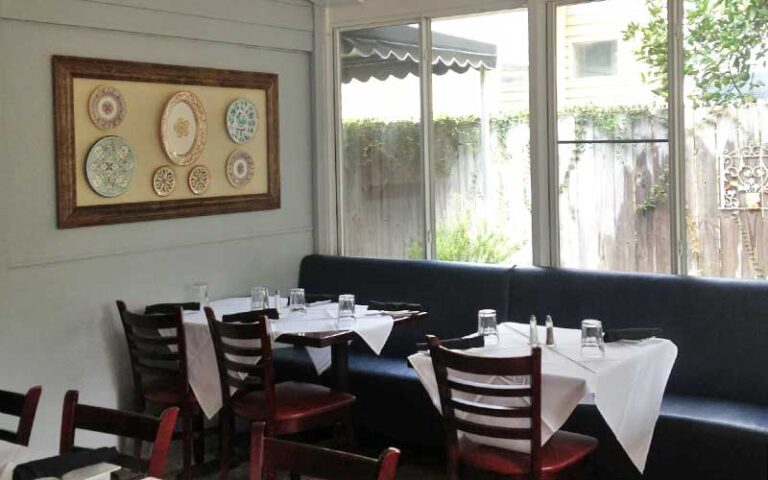 dining seating with simple decor and window at espana restaurant tapas fernandina beach amelia island