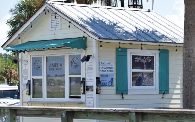 dock with tour agency building and teal awnings at amelia river cruises charters fernandina beach