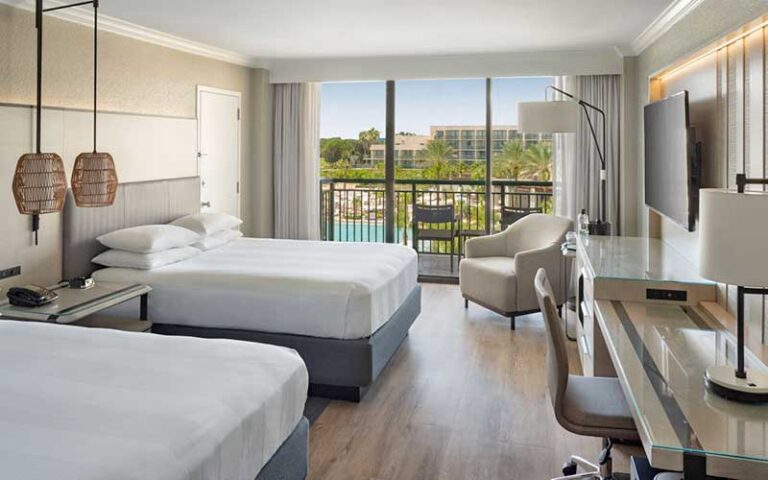 double bed suite with balcony overlooking pool area at orlando world center marriott