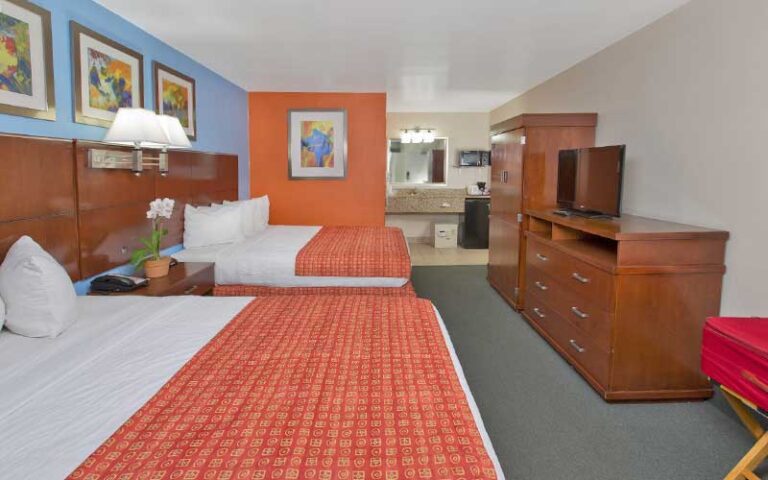 double queen suite with orange and blue accents at flamingo waterpark resort kissimmee