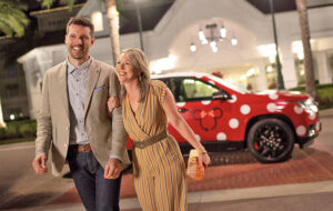 dressy couple walking from minnie van drop off at resort entrance walt disney world