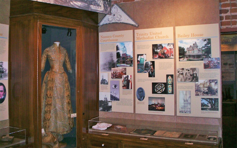 exhibit featuring historic dress and books at amelia island museum of history