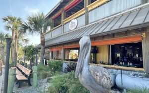 exterior of two story restaurant with pelican statue at salty pelican bar grill fernandina beach amelia island