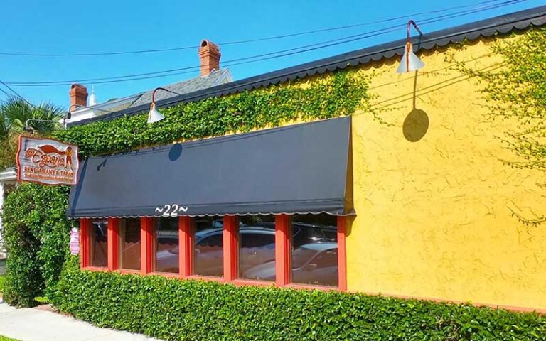 exterior of yellow restaurant with awning at espana restaurant tapas fernandina beach amelia island