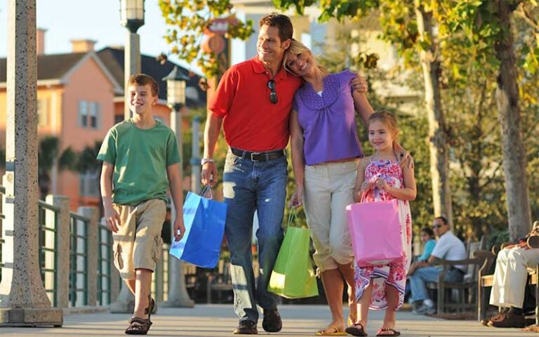 family of four walking lakeside at celebration town center kissimmee