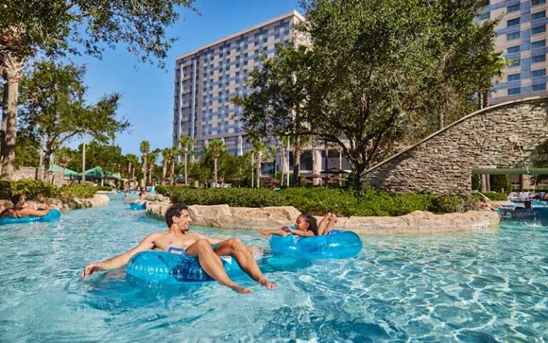 father and daughter tubing in lazy river at signia by hilton orlando bonnet creek