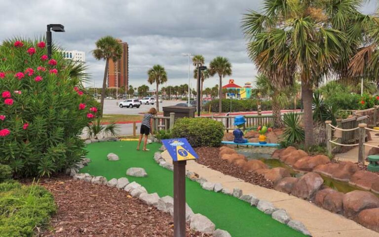 first hole of mini golf course with golfer at ufo golf pensacola beach