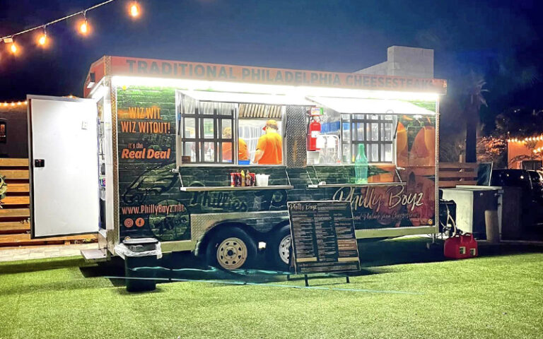 food truck trailer in lawn area at night with string lights at palace saloon fernandina beach amelia island