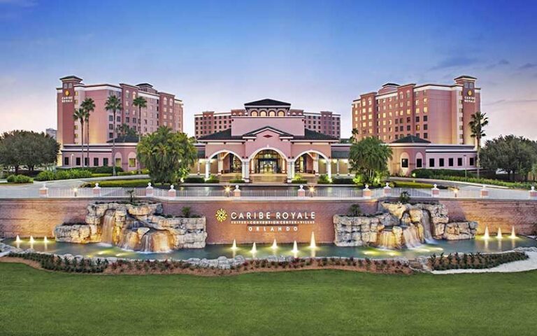 front exterior of resort with lawn and water feature sign at caribe royale orlando