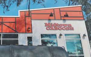 front of building with sign and grill at midtown caboose tallahassee