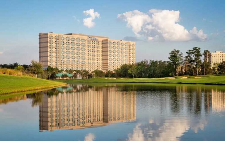 high rise hotel viewed across lake at signia by hilton orlando bonnet creek