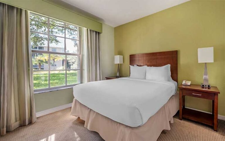 king size bed in green suite with view at hilton vacation club mystic dunes orlando celebration