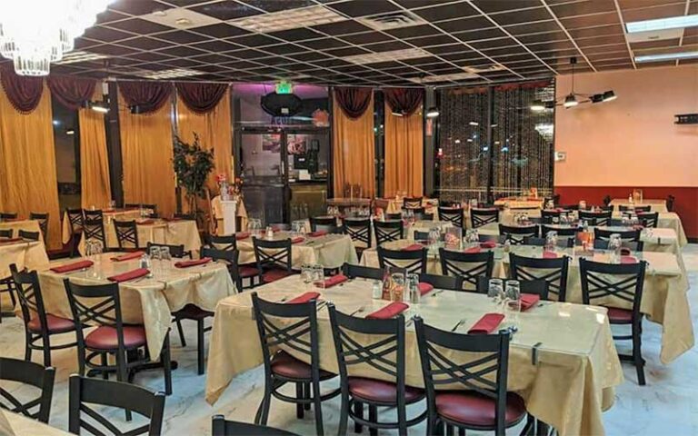 large dining area in restaurant with chandelier at essence of india tallahassee