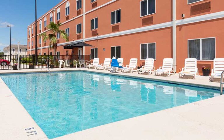 large pool with hotel building behind at amelia hotel at the beach fernandina beach amelia island