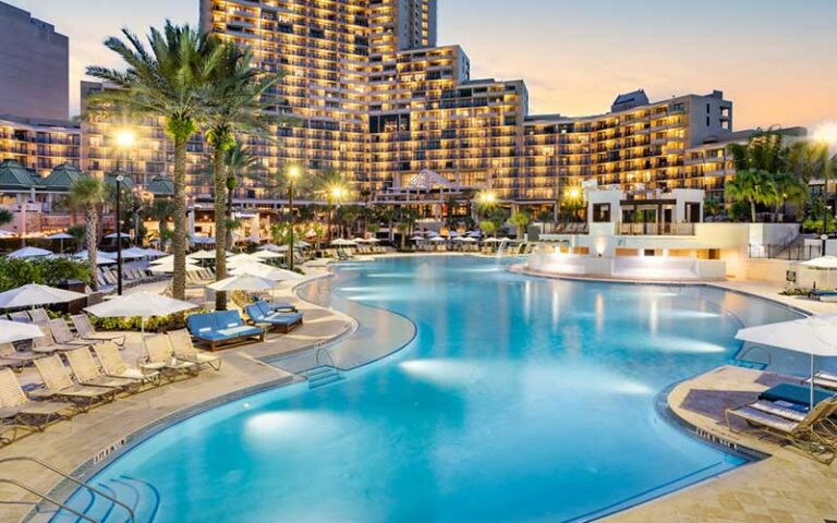 lighted high rise hotel and pool at night at orlando world center marriott