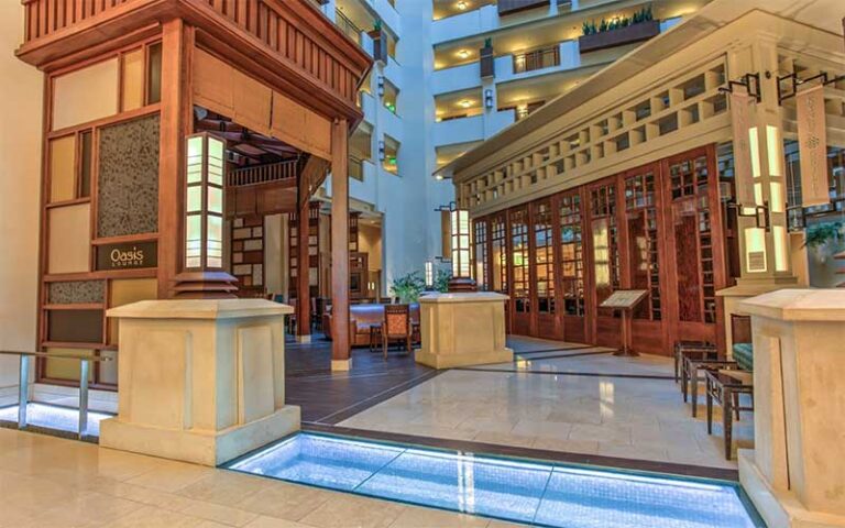 lobby with atrium and oasis restaurant at embassy suites by hilton orlando lake buena vista south kissimmee