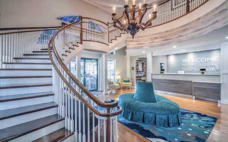 lobby with grand staircase and welcome desk at hampton inn suites amelia island historic harbor front fernandina beach