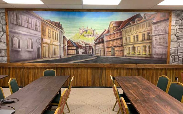 long tables with mural on wall at coliseum of comics kissimmee