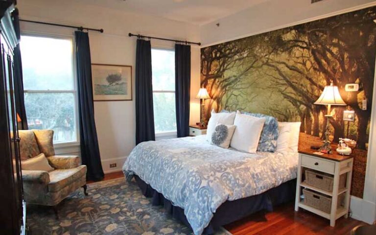 luxury bedroom with windows king size bed and wall tapestry at hoyt house bed breakfast fernandina beach amelia island