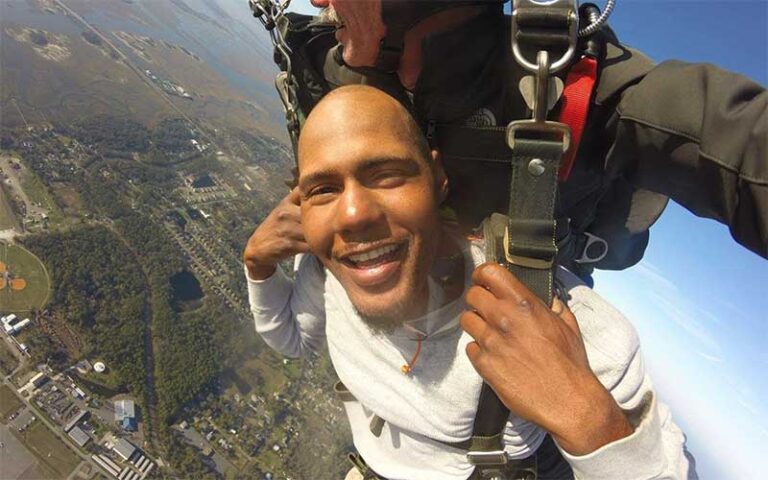 man on tandem jump with selfie over landscape at skydiving jacksonville amelia island