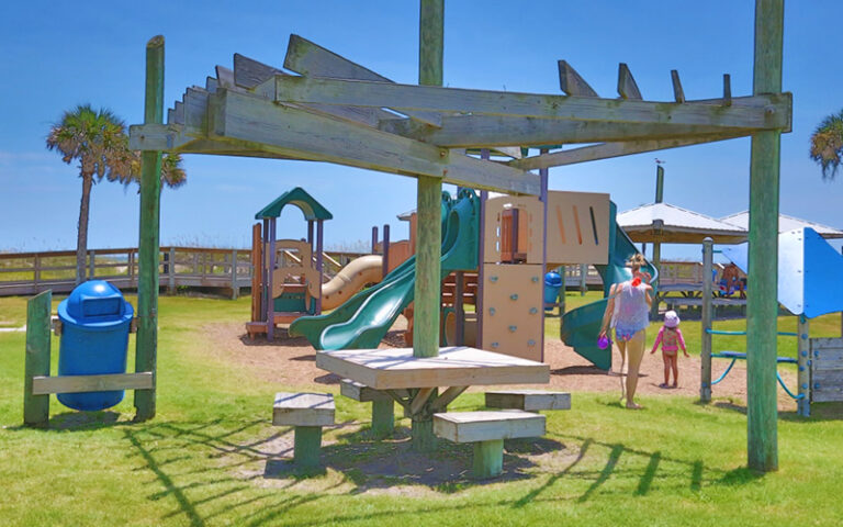 mom and kid on playground at main beach park fernandina amelia island