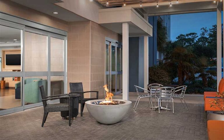 outdoor patio at night with fire pit at home2 suites by hilton tallahassee state capital