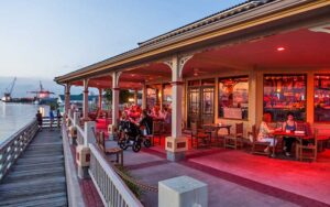 outdoor patio dining along dock with boats and harbor at dusk at bretts waterway cafe fernandina beach amelia island