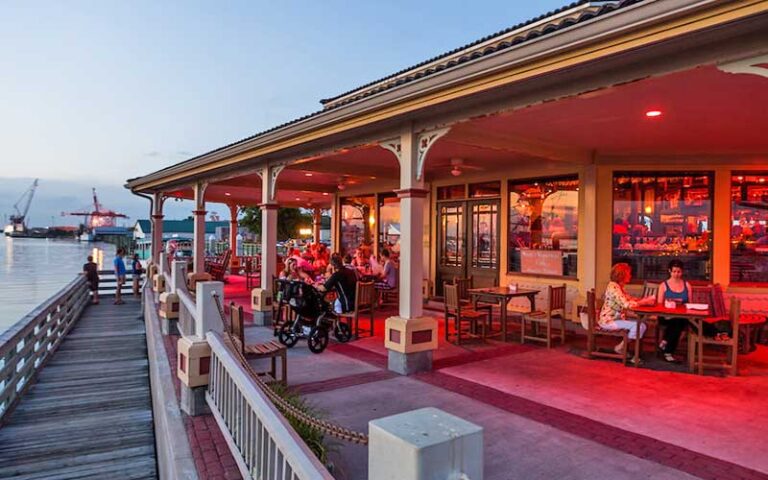 outdoor patio dining along dock with boats and harbor at dusk at bretts waterway cafe fernandina beach amelia island