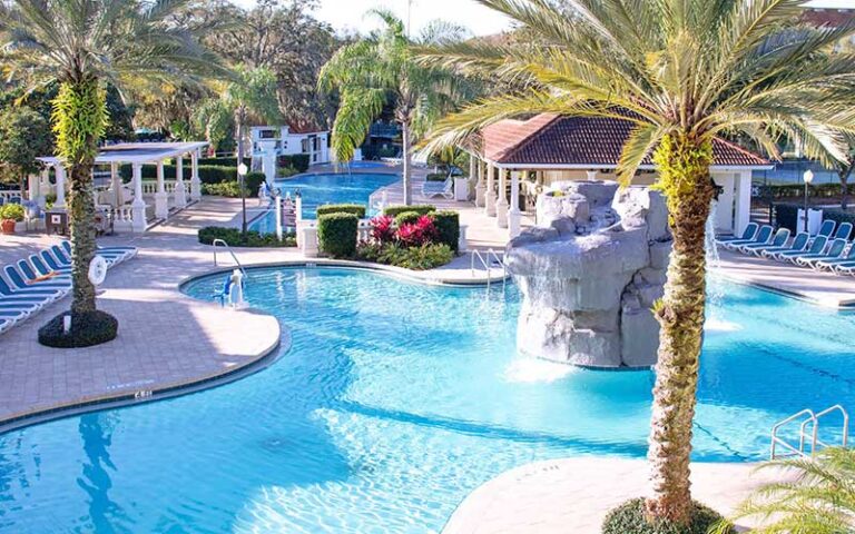 outdoor pool areas with waterfall and palms at star island resort spa kissimmee