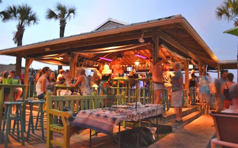 outdoor tiki bar with lighting at dusk at sliders seaside grill fernandina beach amelia island