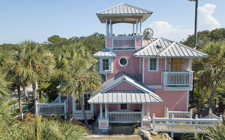 pink cabana style home with trees at island falls adventure golf amelia island