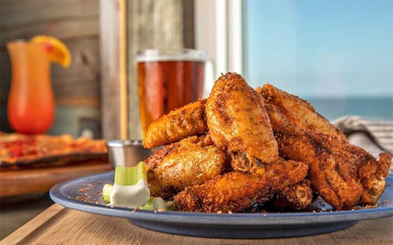 plate of wings with drinks and ocean view at sandbar amelia island fernandina beach