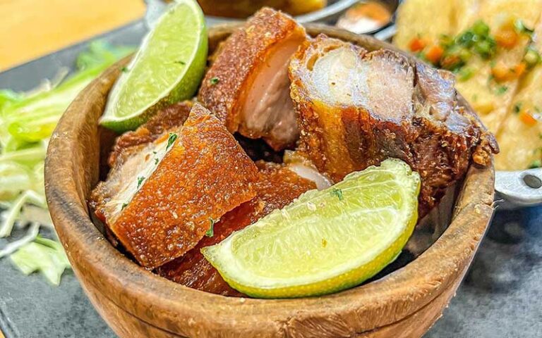 pork with limes in wooden bowl at perico ripiao latin food kissimmee