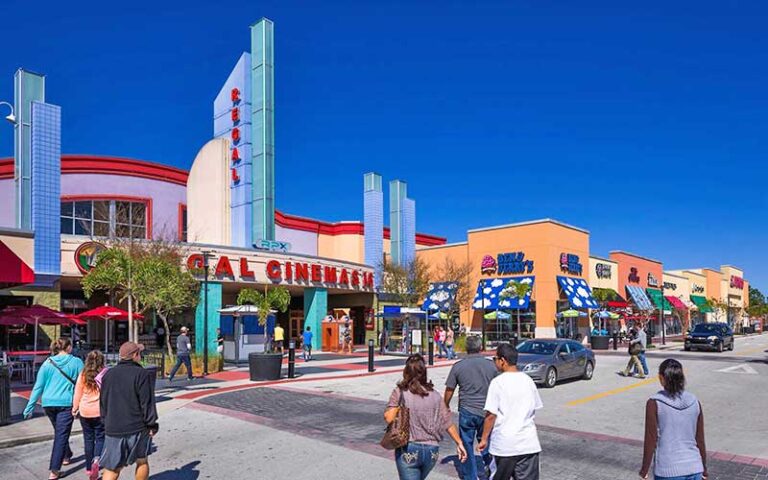 regal movie theater with row of stores and people at the loop kissimmee