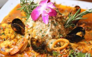 rice and seafood dish with flower at perico ripiao latin food kissimmee