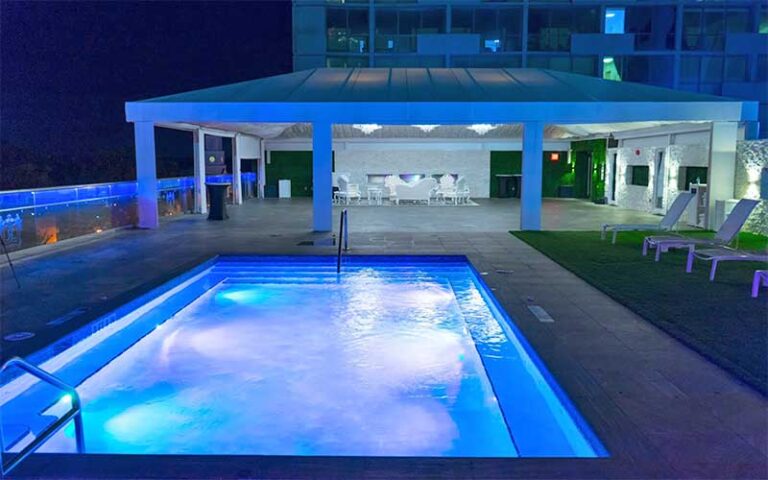 rooftop pool at night with blue lighting at doubletree by hilton hotel tallahassee