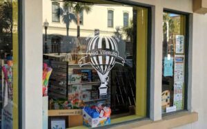 shop windows with toys and logo at villa villekulla neighborhood toy store fernandina beach amelia island