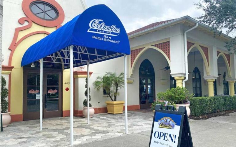 sidewalk entrance to restaurant with sign and awning at celebration town center kissimmee