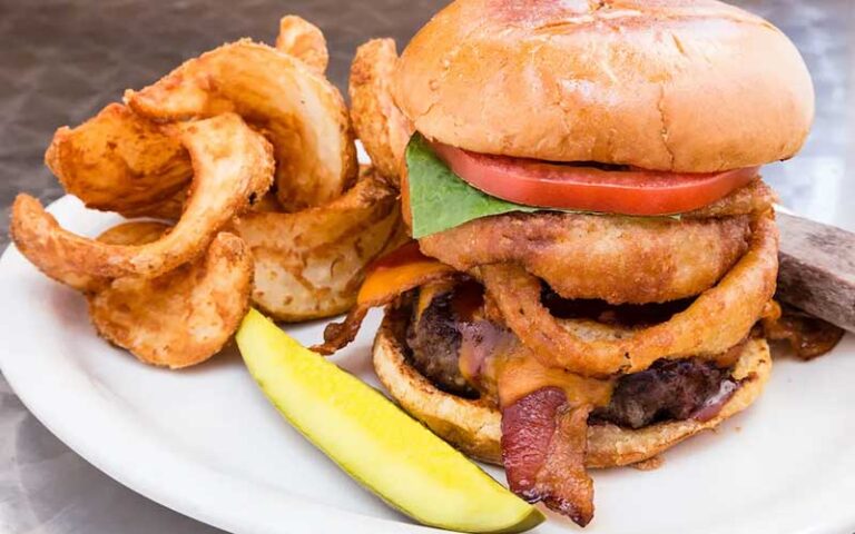 stacked burger with sides at salty pelican bar grill fernandina beach amelia island