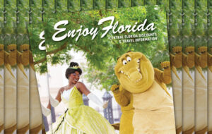 stacks of magazines with princess tiana and crocodile character dancing under trees for enjoy florida magazine cover